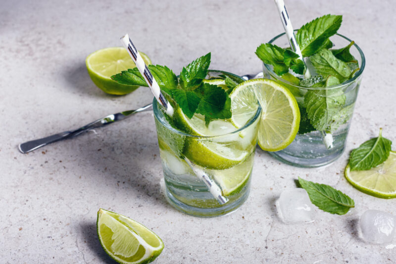 Non-alcoholic drinks with lime, mint and ice cubes on the table - a refreshing alternative to alcohol