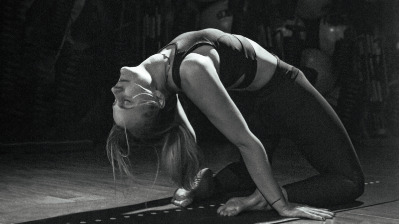 A person doing stretching or yoga in a fitness club - a symbol of relaxation, focus and stress reduction through physical activity.