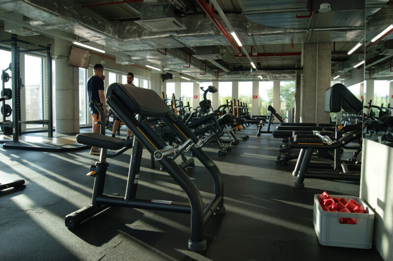 Trainers in the strength area of Just Gym Łódź Piotrkowska - a modern space with professional fitness equipment.