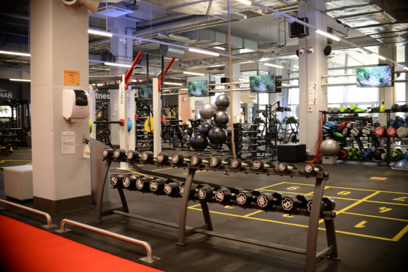 Just Gym Poznań Bulgarska gym - dumbbells, fitness balls and functional training equipment in a spacious interior.
