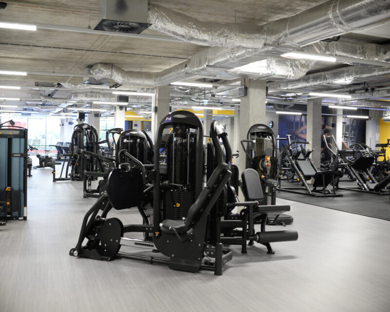 Free weights zone and leg training machines at Just Gym Łódź Rembielińskiego - modern Matrix equipment.