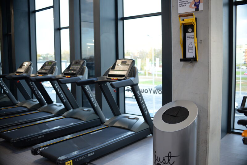 Matrix treadmills in the Just Gym Słupsk gym - modern fitness equipment next to panoramic windows.