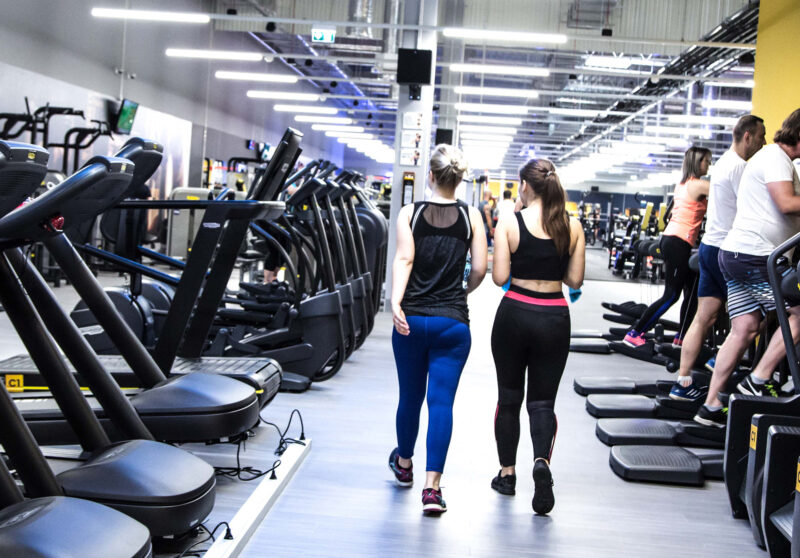 The cardio zone at Just Gym Poznań Szwajcarska - modern treadmills and orbiters in the club's spacious interior.