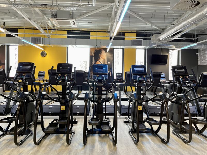 The cardio zone in the Just Gym Gniezno gym with state-of-the-art Matrix orbiters arranged in rows.