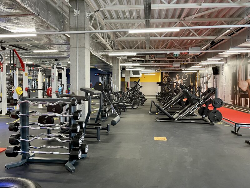 The free weights and machines zone at Just Gym Gniezno - state-of-the-art strength training and bodybuilding equipment.