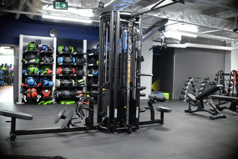Strefa treningu funkcjonalnego w Just Gym Łódź Rewolucji – sprzęt fitness, hantle i piłki treningowe w przestronnym wnętrzu.