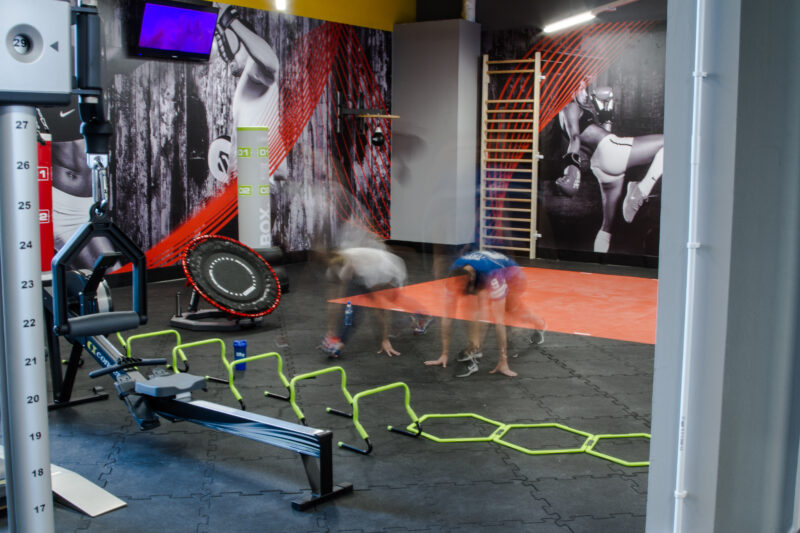 Interval and functional training zone at Just Gym Plock - trampoline, ladders and exercise equipment in a modern interior.