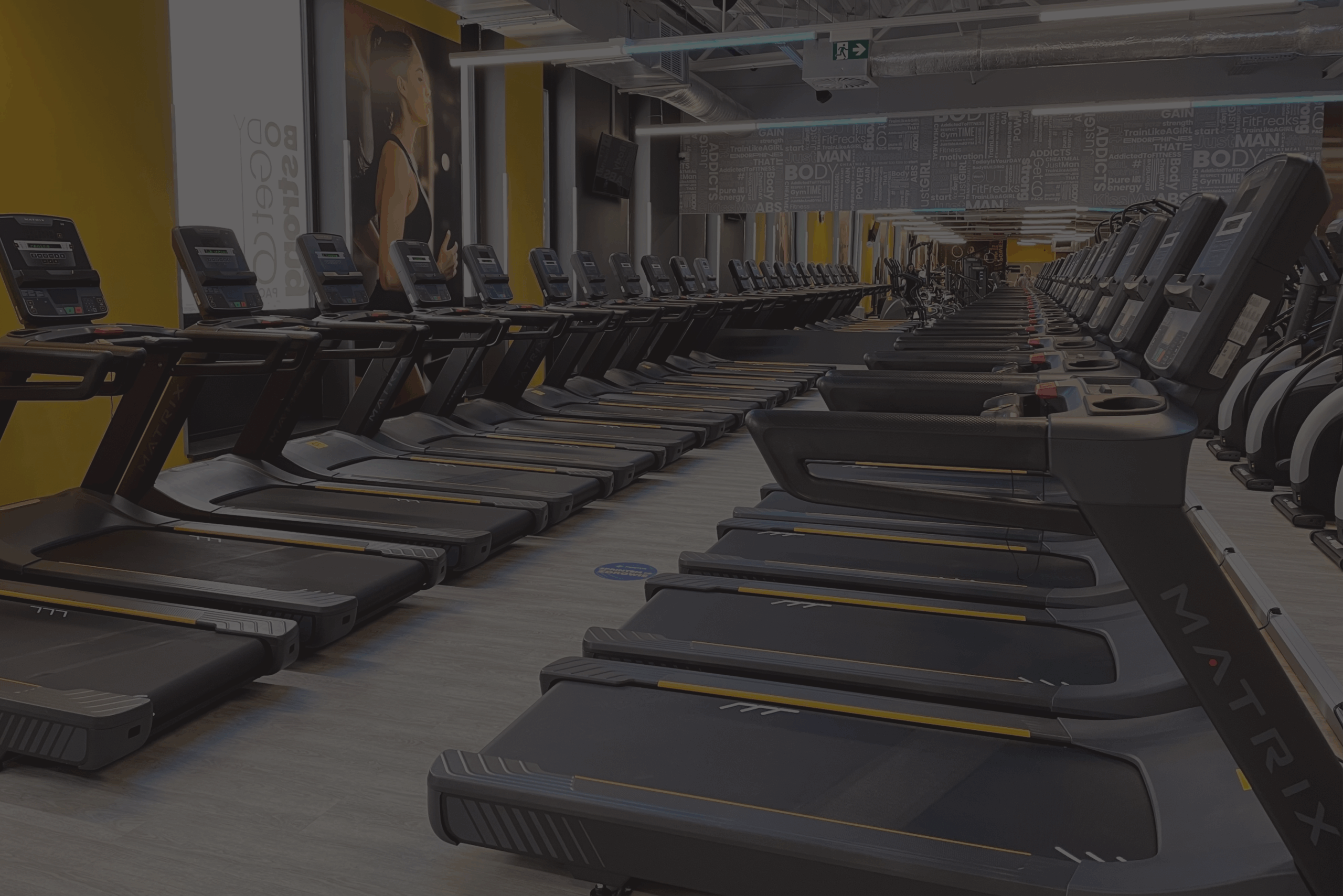 Gniezno gym - cardio equipment in an industrial club interior.