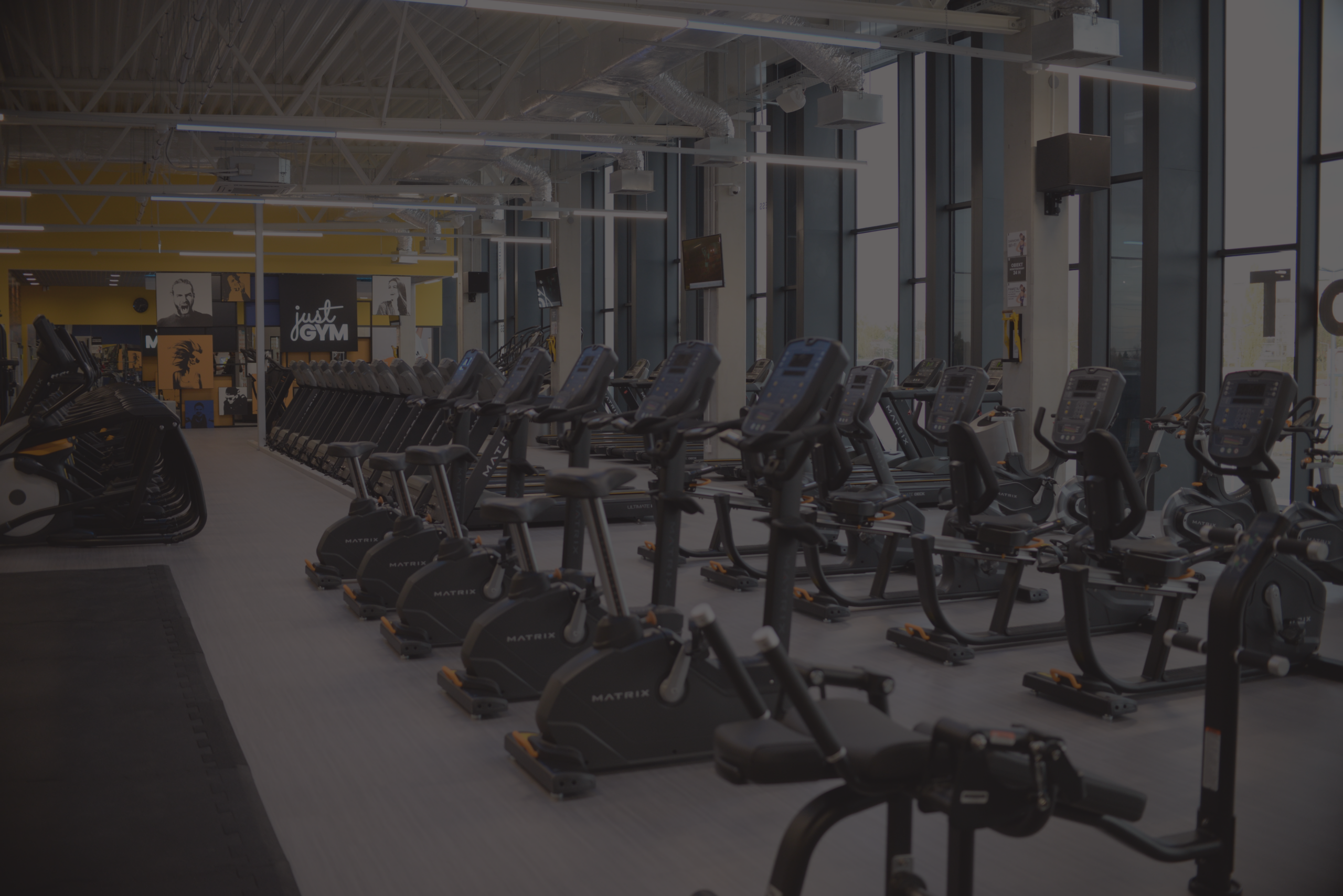 Modern fitness club Opole, cardio area with large windows.